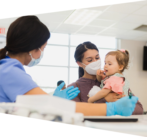 Mother holding child at urgent care visit