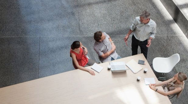 Employees sitting at conference table