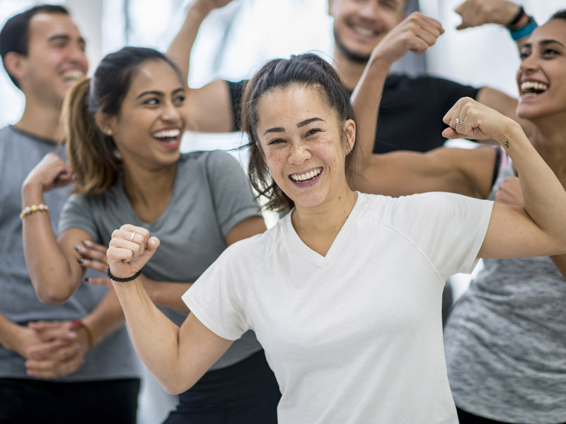 Group of people flexing their biceps