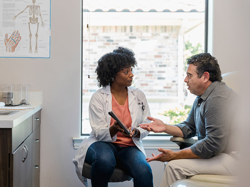 Man talking to a doctor while at a doctor visit