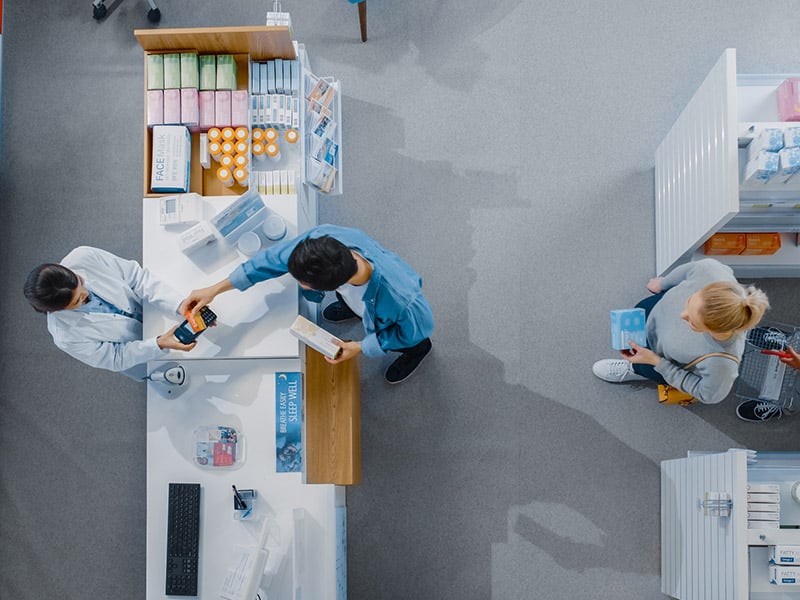 Top down view of people interacting at a pharmacy