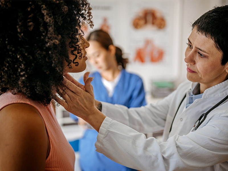 Women having her throat checked in a doctor's office